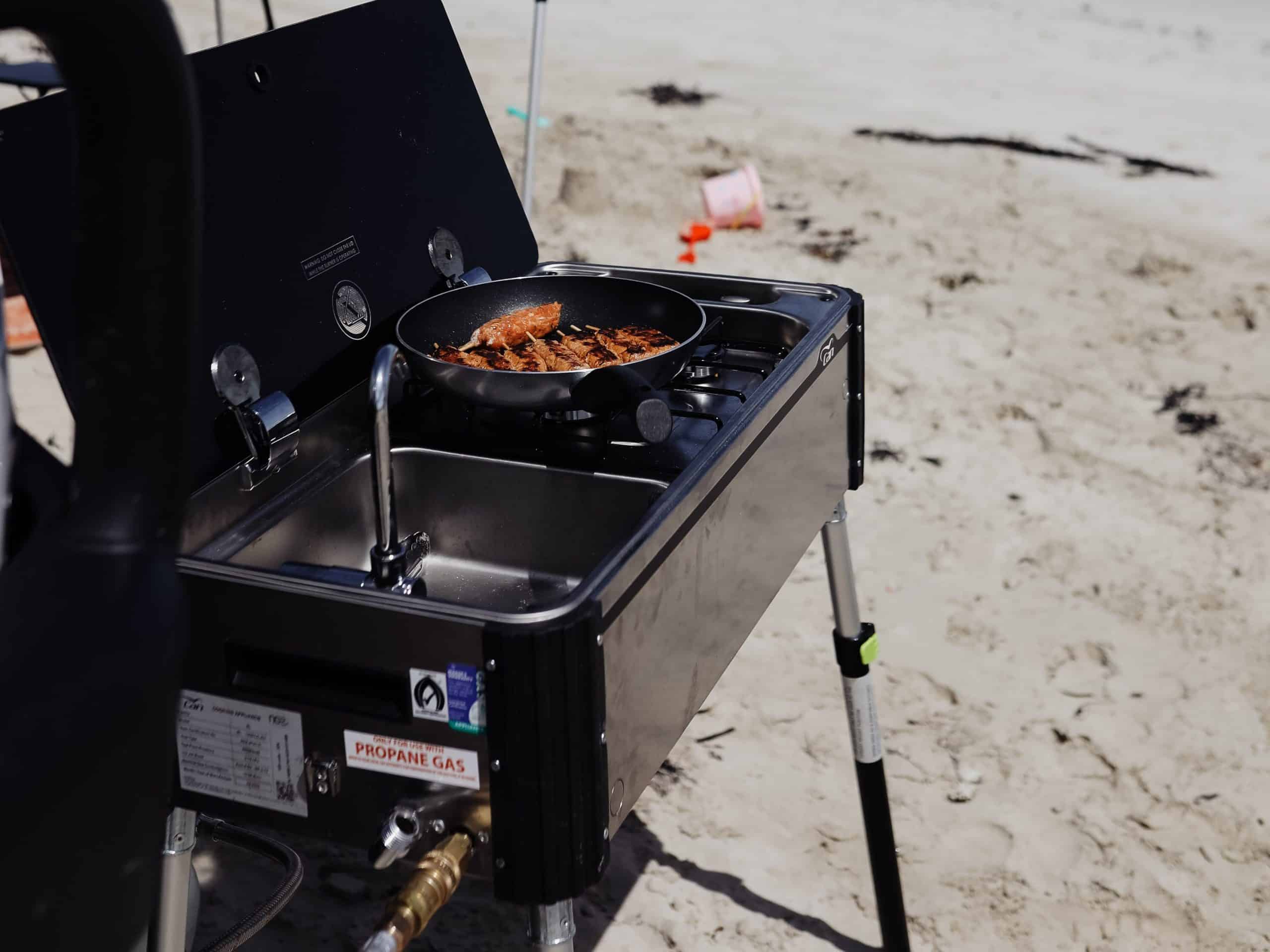 A close up of the CAN Portable Slide Out Kitchen supported with height adjusted legs