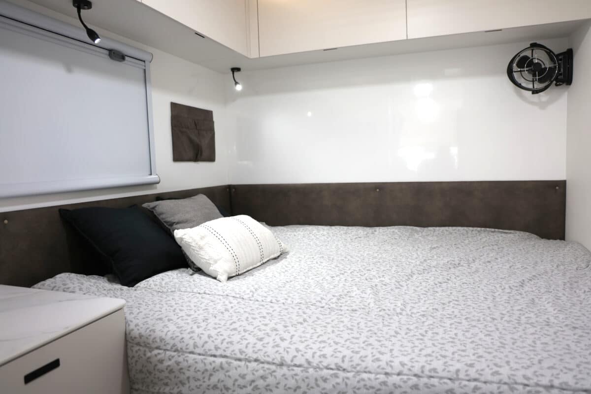 The east-west bed within this JB Touring motorhome layout, one of 7 available delivers private quarters in a motorhome that's drivable on a standard license.