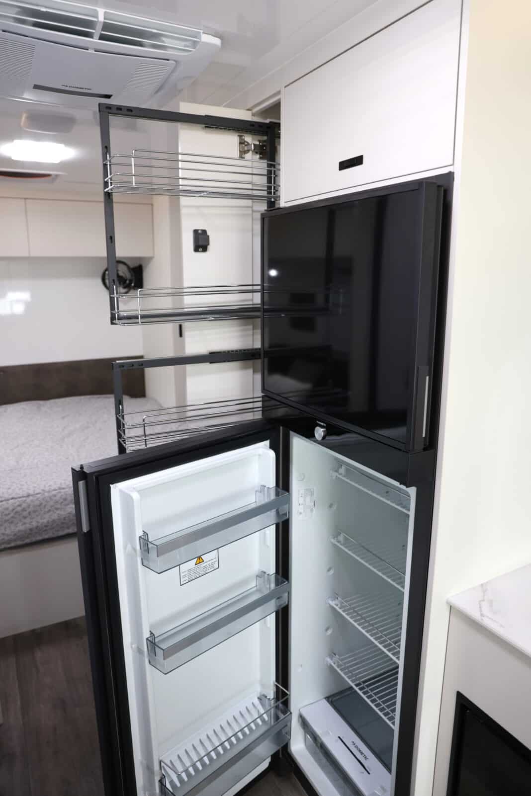 The 224L compressor fridge next to a full height pantry allows travellers to cook confidently in this JB Touring motorhome layout, one of 7 available.