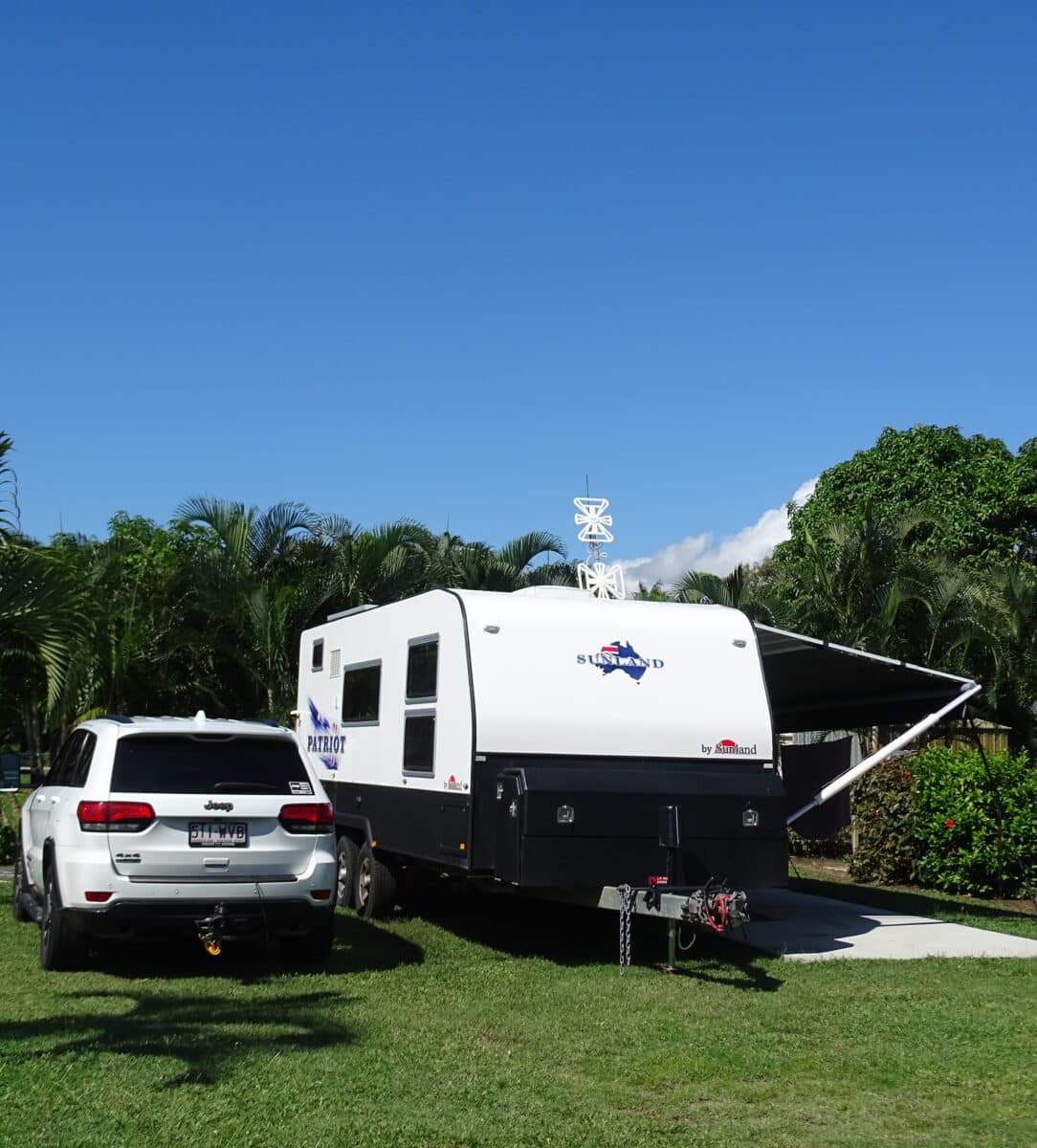 Camped up comfortable, a sunland caravan next to a jeep.