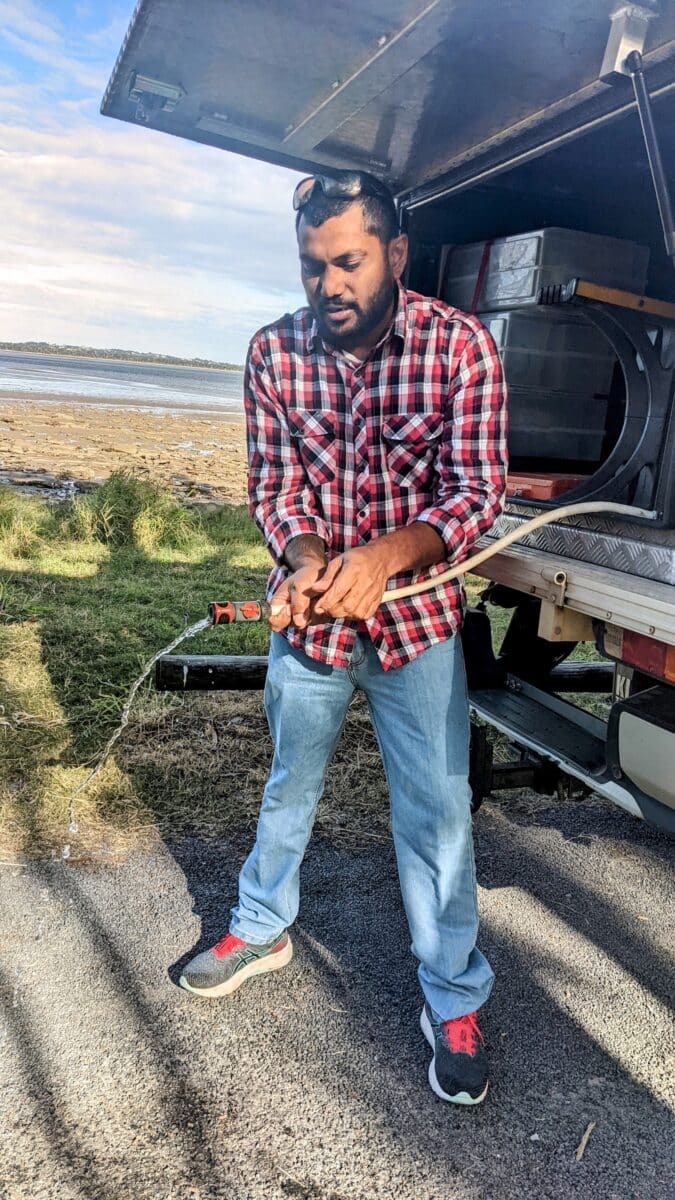 Simplifying water storage access in a 4WD canopy using a hose extension hack