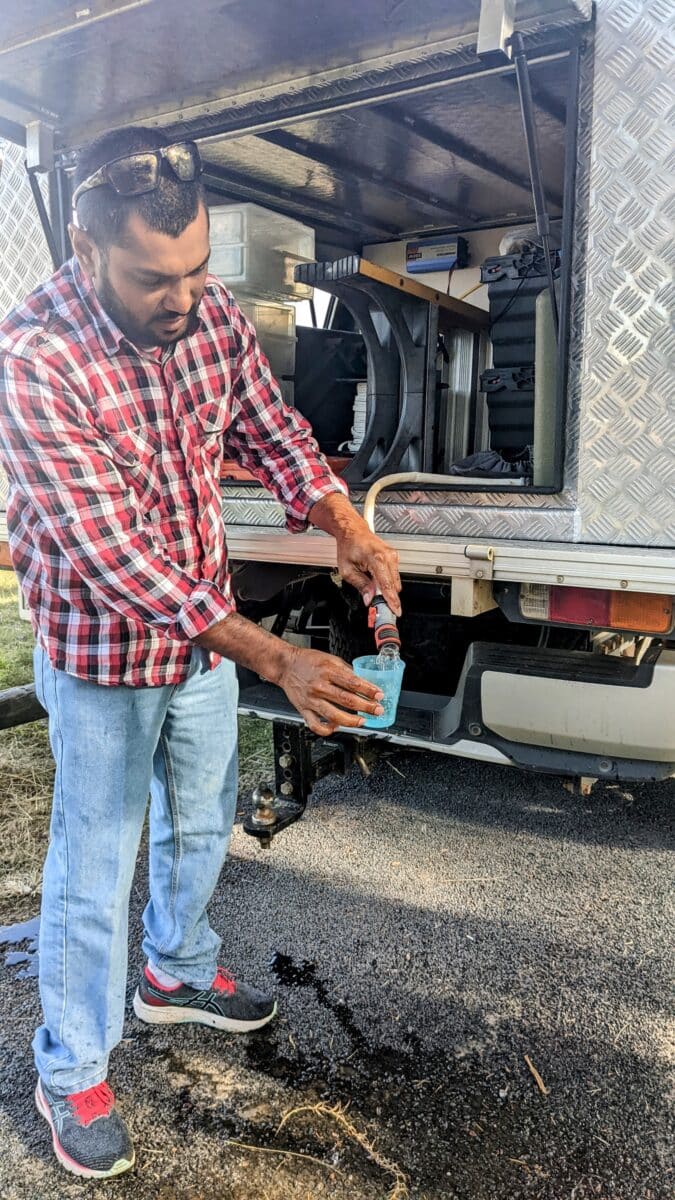 Simplifying water storage access in a 4WD canopy using a hose extension hack