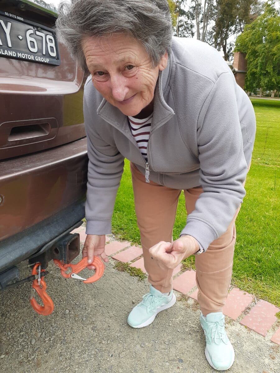 Close up of Anne Westbury - the journalist's wife - holding an Austlift hook that's attached to her vehicle