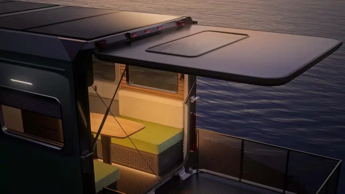 Off-grid living area of the Evotrex RV trailer with rear access open near water