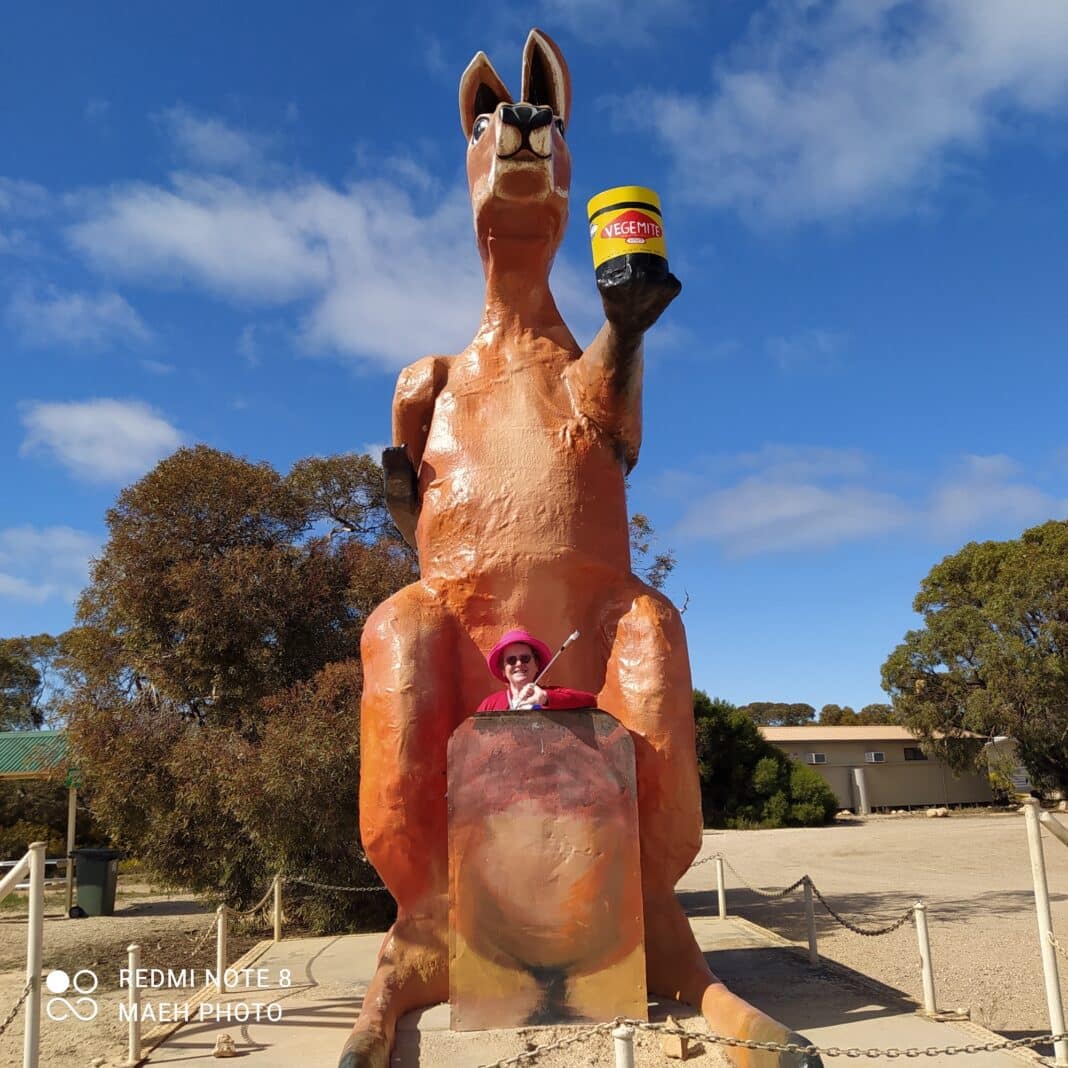Alison Huth stands in front of a giant kangaroo - the first hole over the border is called the border kangaroo