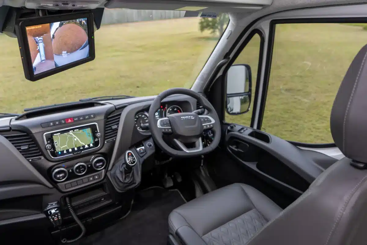 Driver’s cab of the Paradise Independence Platinum motorhome showing Iveco dashboard and camera display
