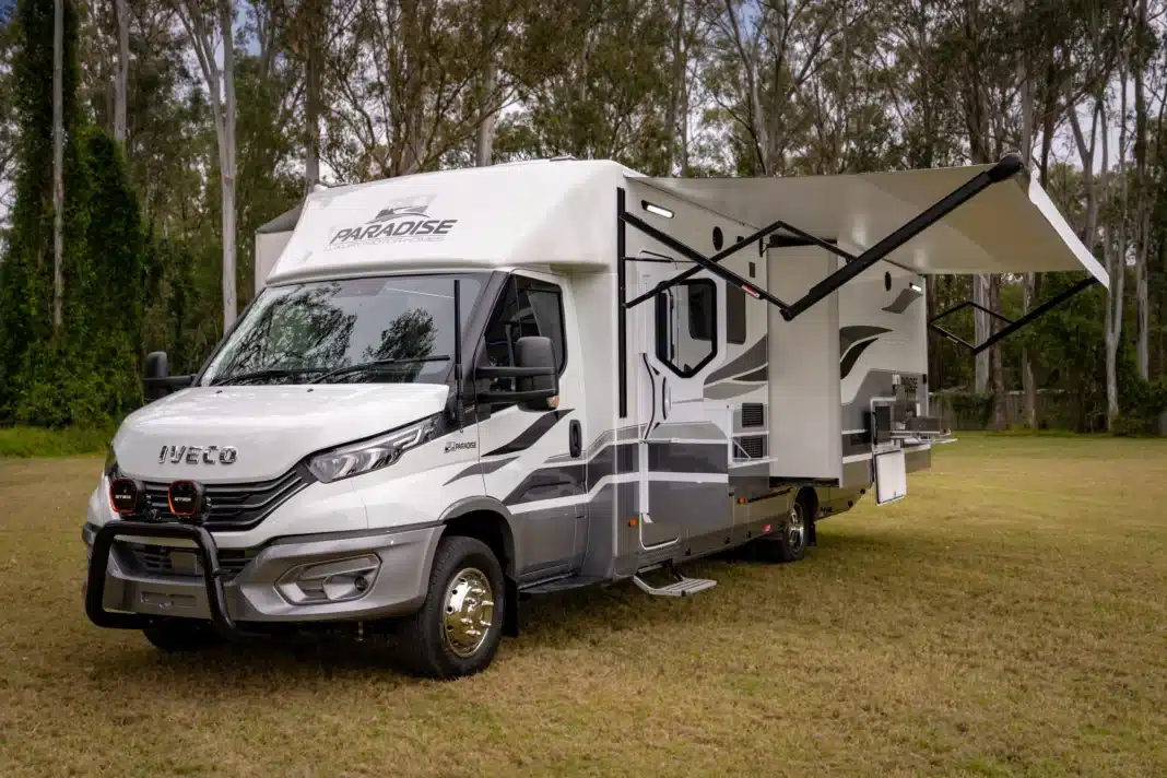 paradise-independence-platinum-slide-outs-deployed Paradise Independence Platinum motorhome with dual slide-outs and awning deployed at camp