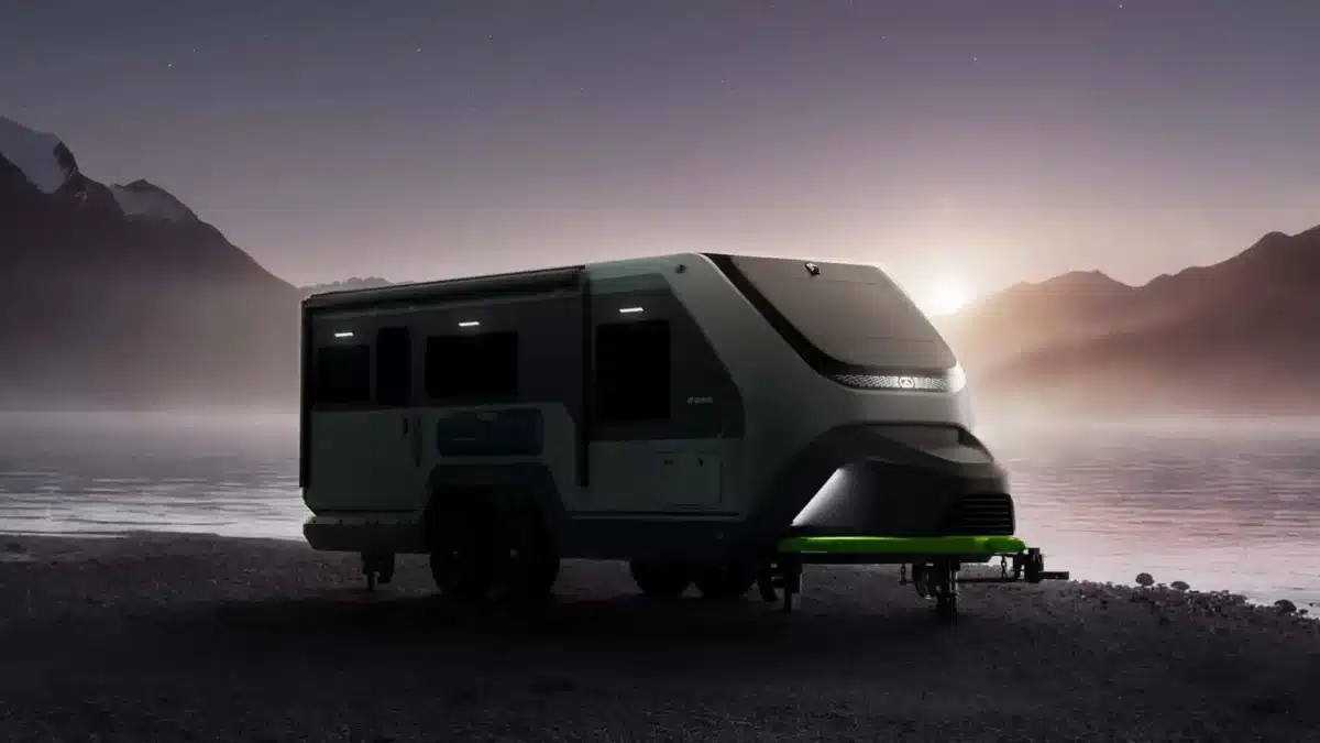 Exterior view of a power-generating RV trailer set up off-grid at dusk