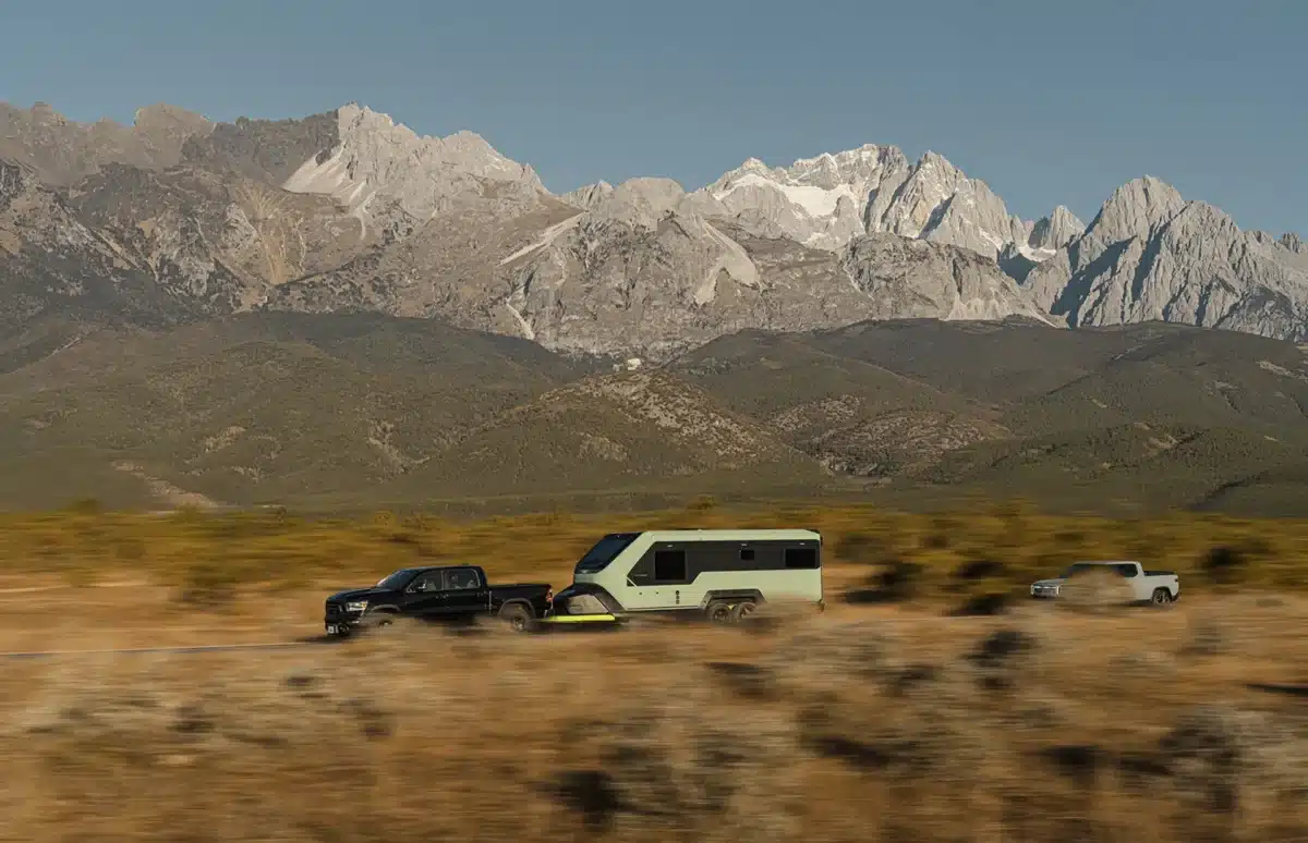 Power-generating RV trailer being towed through a remote off-grid landscape