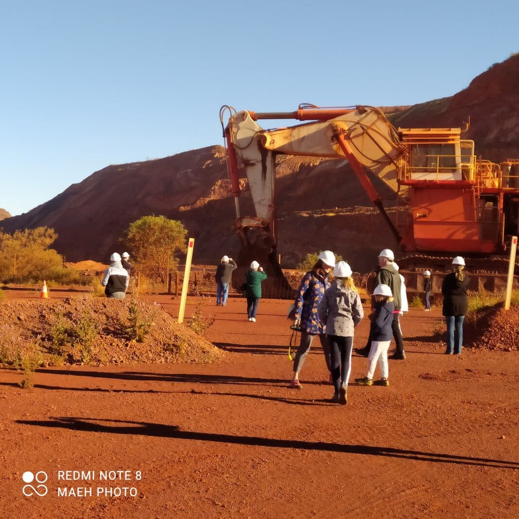 Rio Tinto Mine Tour guests inspect the large machinery used within the Tom Price Mine
