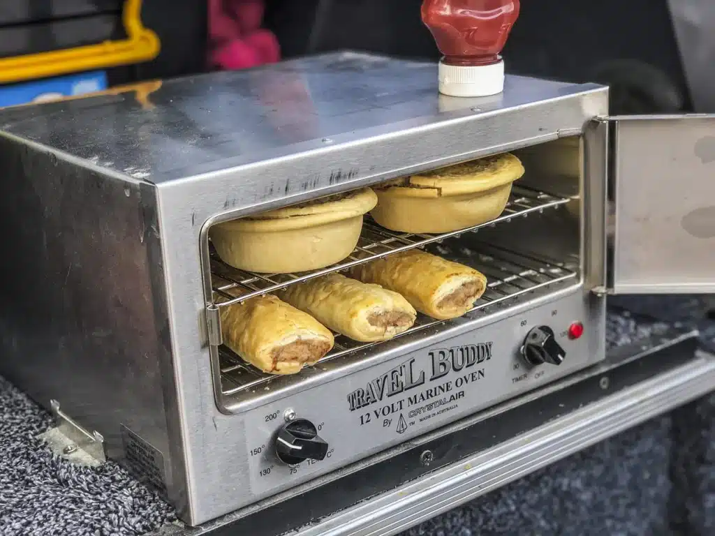 12v oven cooking pies and sausage rolls in the back of a ute 4x4