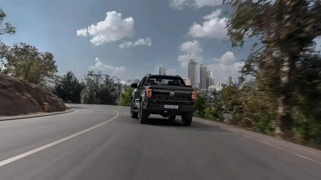 2026-volkswagen-amarok-driving-rear-view Rear view of the 2026 Volkswagen Amarok driving on a highway