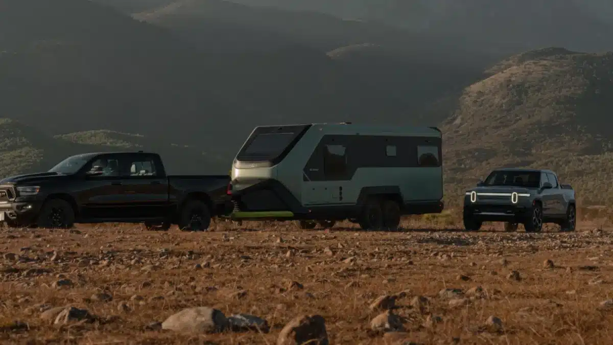 Evotrex PG5 RV trailer being towed through remote desert terrain
