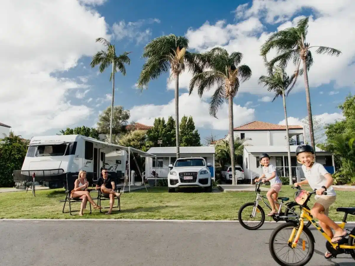 Children riding bikes through an Australian caravan park during a family holiday