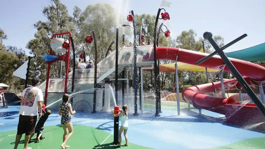Children playing at a splash park in a holiday park during summer