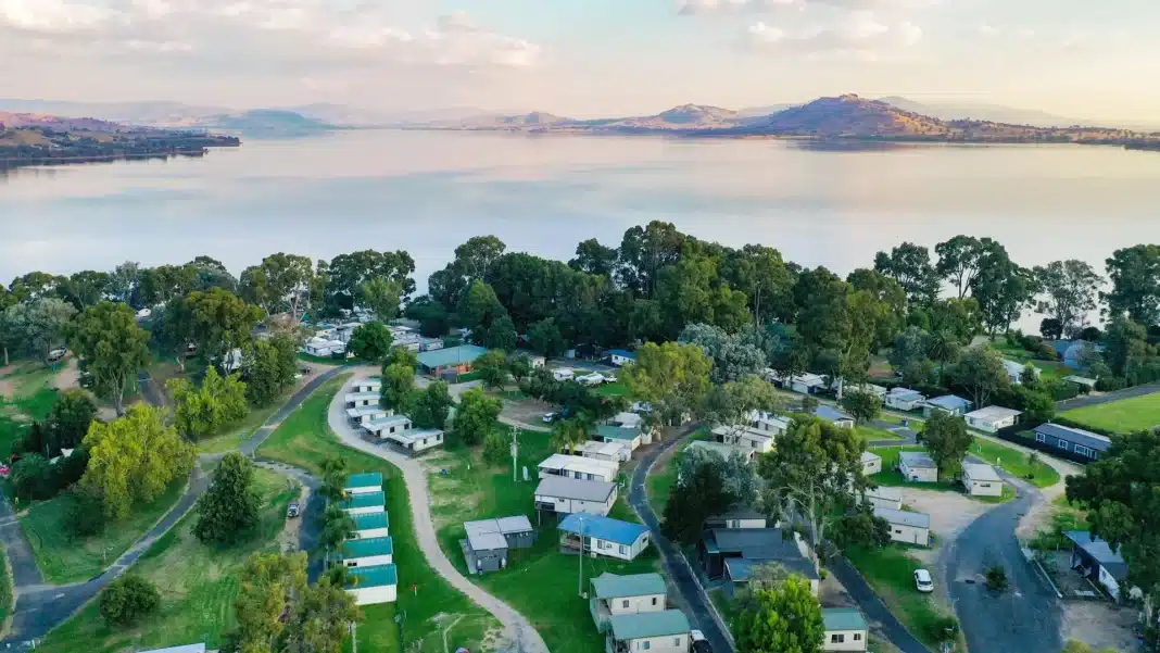 holiday-park-aerial-lakeside-summer-australia Aerial view of a holiday park beside a lake during summer in Australia