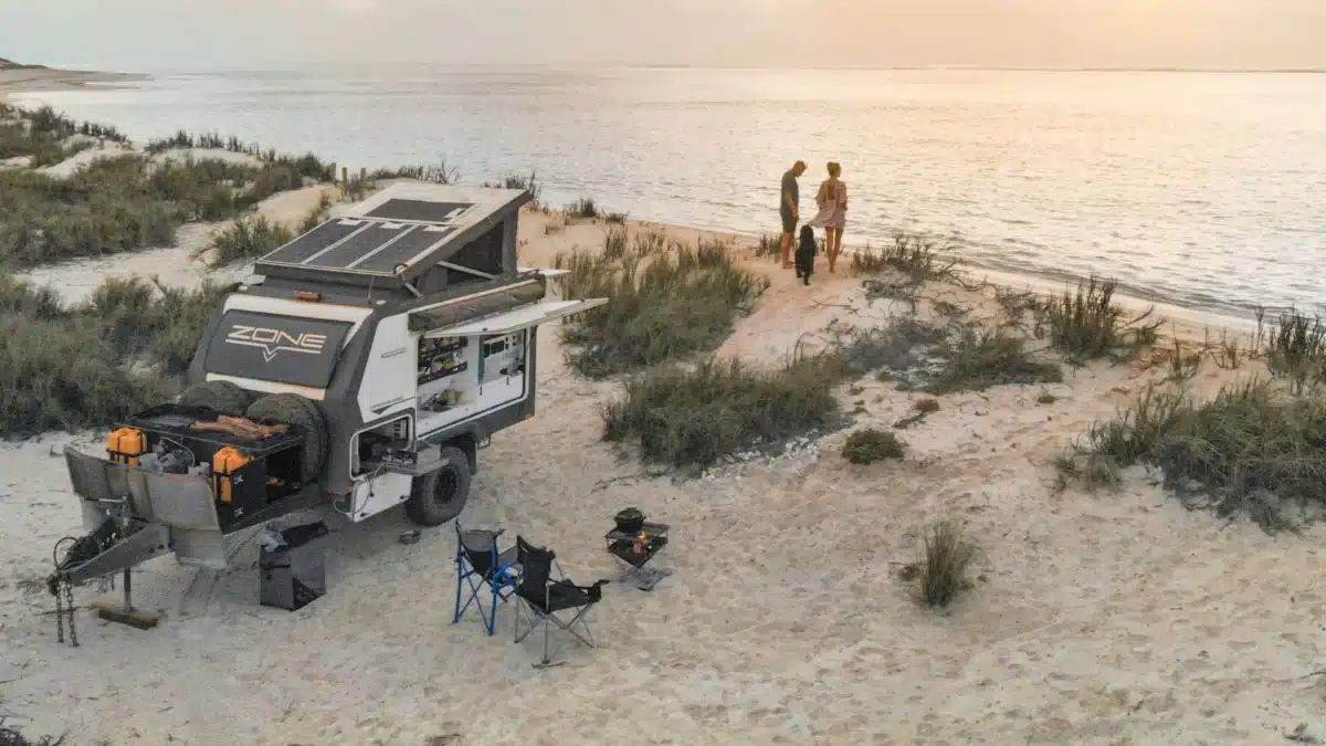 Camper trailer set up near the beach along the Ningaloo Coast, a popular destination affected by new camping booking release dates.