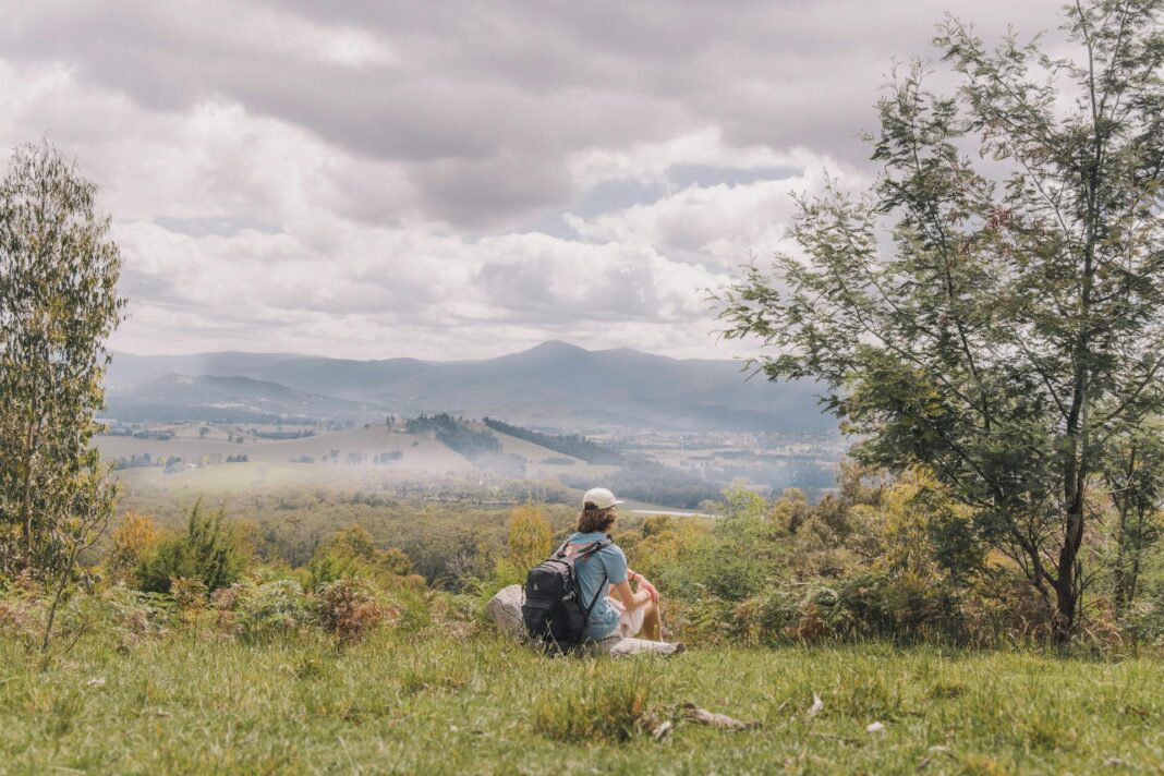 Coolcation hero image person sitting at high altitude in victorian high country - yarra valley