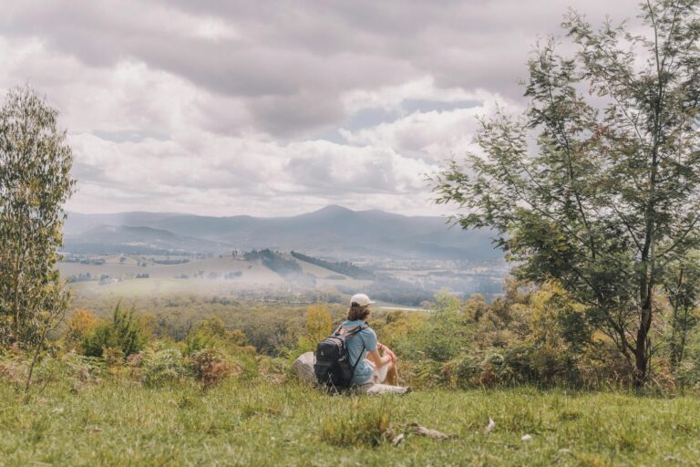 person sitting at high altitude in victorian high country - yarra valley