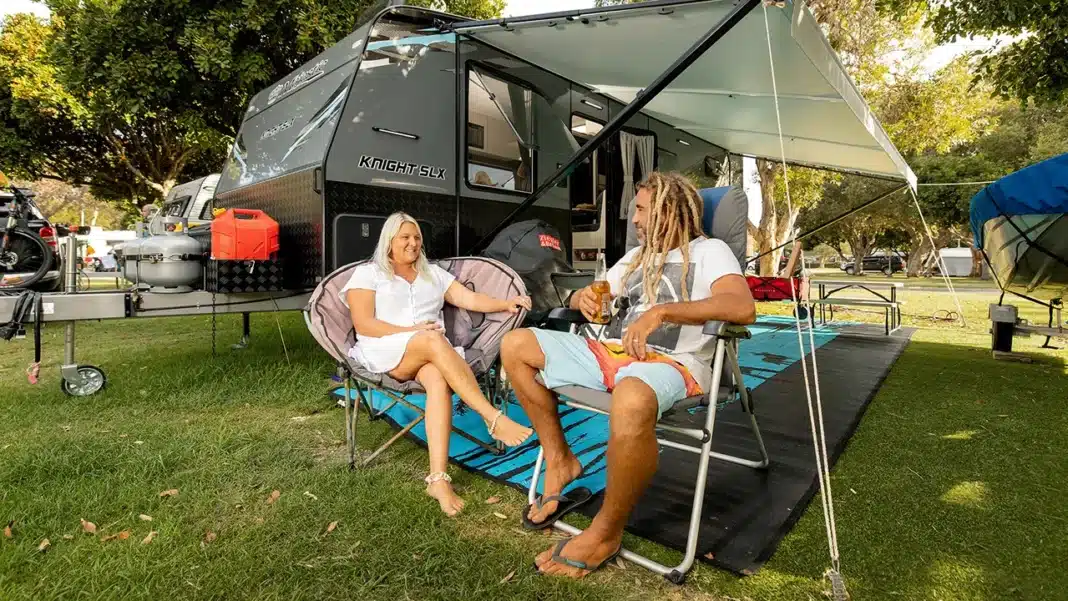 Travellers relaxing at a powered caravan site in an Australian holiday park