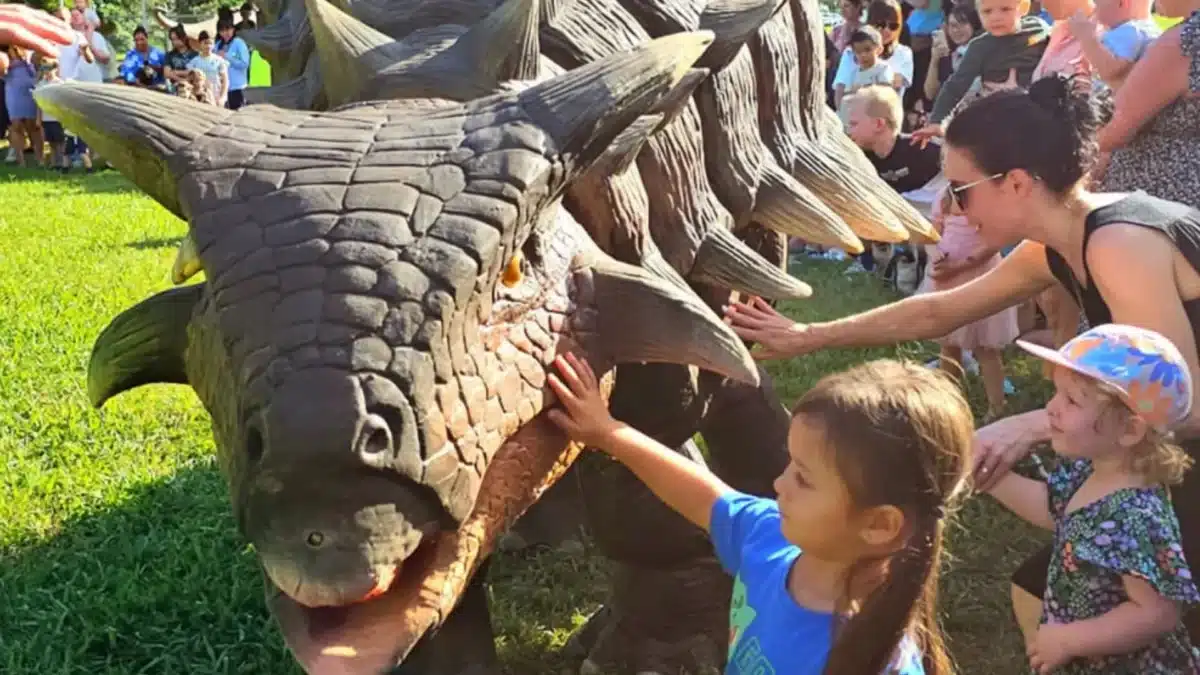 Children touching a dinosaur display at a family-friendly dinosaur exhibit in Sydney