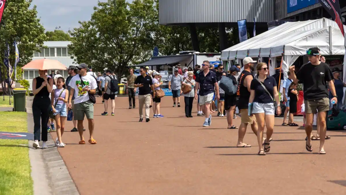 Visitors walking between caravan and camping exhibits at the Victorian Caravan & Camping Supershow in Melbourne.