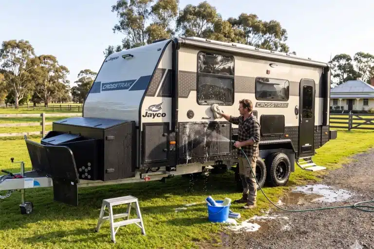 australian man washign new caravan after first trip, ensuring the caravan is looked after and kept in good condition throughout ownership
