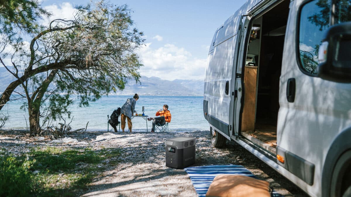 lifestyle image of a couple camping at the edge of water