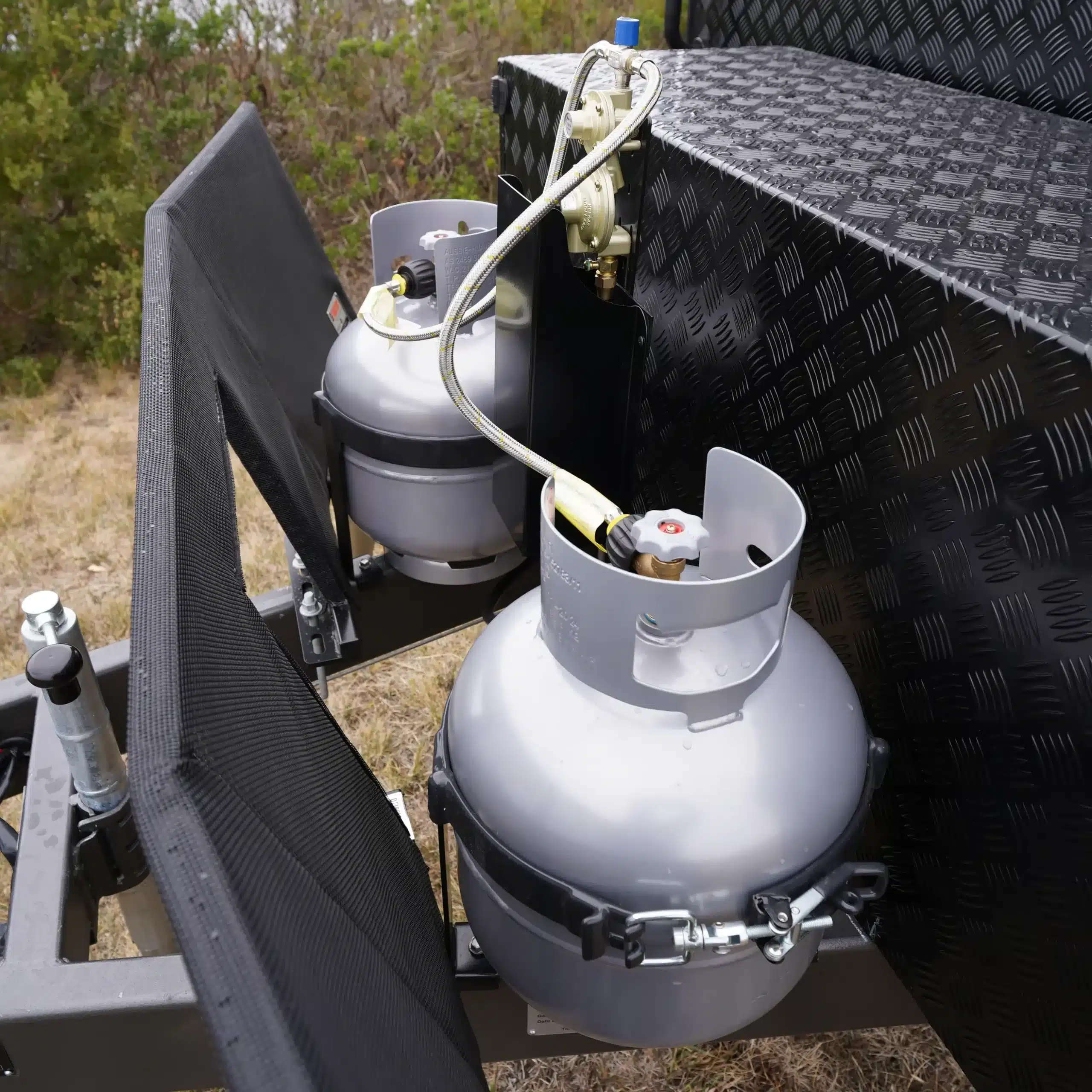 close up of lpg gas bottles installed on the front of caravan a-frame