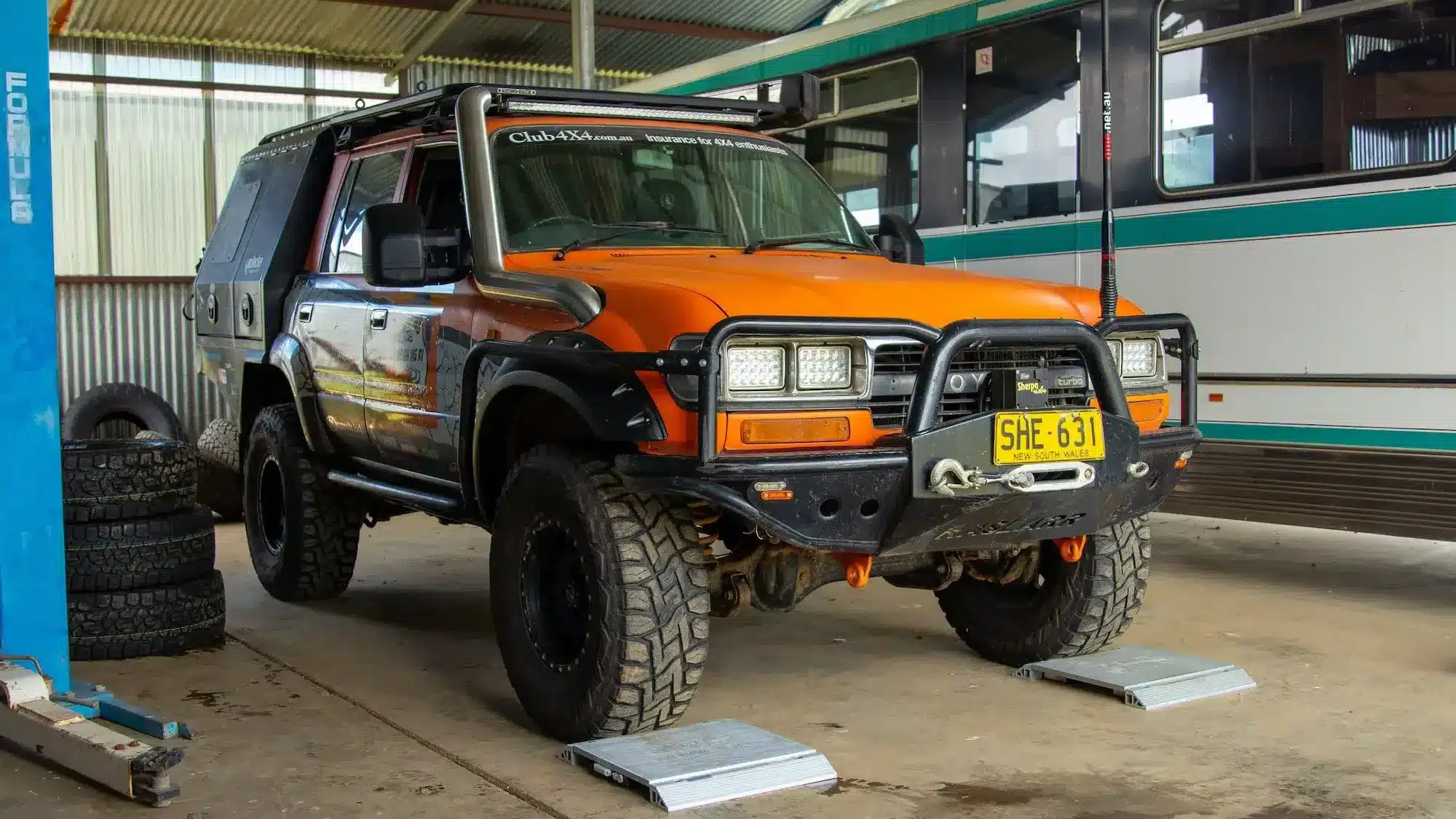 4wd or 4x4 being weighed in mechanic shop
