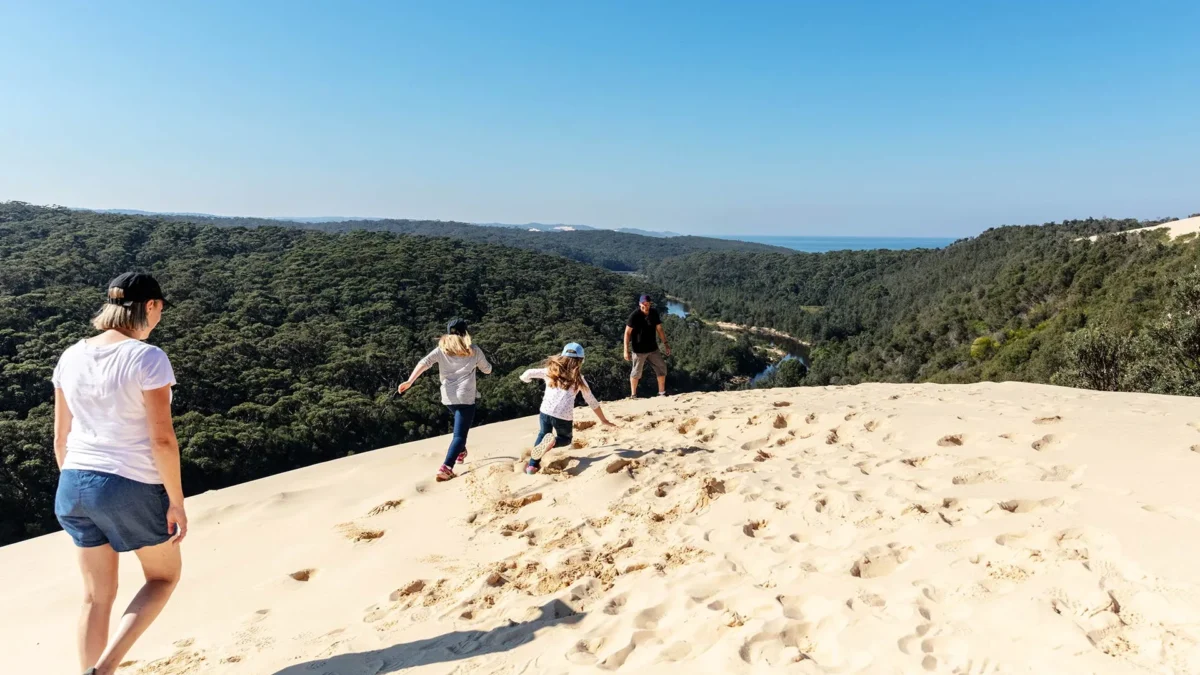 Walkers crossing coastal sand dunes in Croajingolong National Park, East Gippsland, near the Thurra River camping area