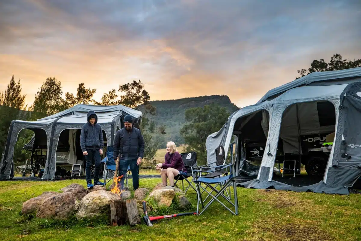 Family enjoying camping at sunset with modular camper and caravan setups