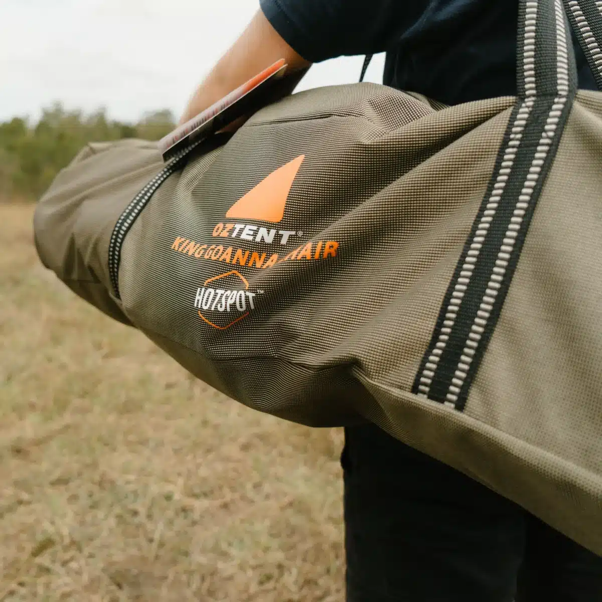 person carrying canvas bag over their shoulder