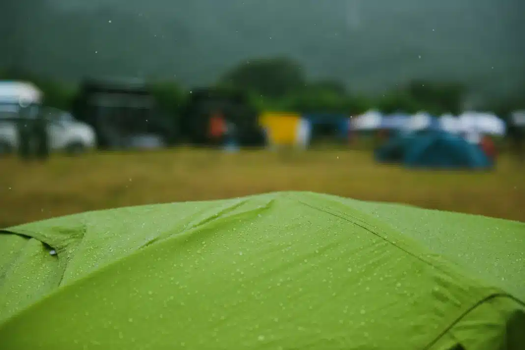 rain-on-tent-waterproof-rating green tent with rain on it close up cinematic vibe