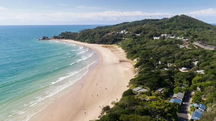 drone or helicopter shot of green coast with blue water
