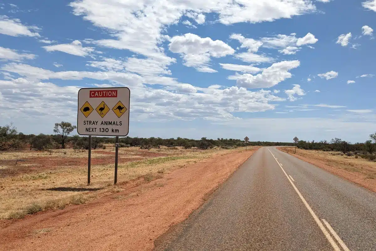 open australian road hwy with caution sign