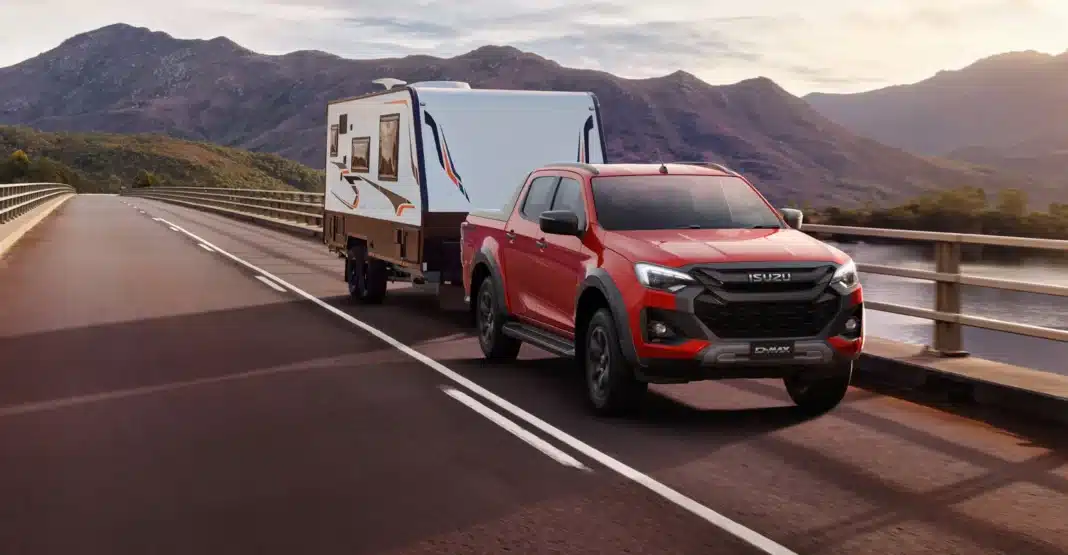 Isuzu D-Max towing a caravan on an Australian highway, reflecting strong dual-cab ute sales in January 2026 vehicle data.