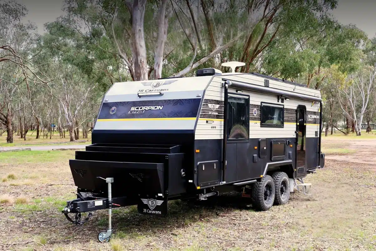 jb scorpion sting caravan on grass near trees