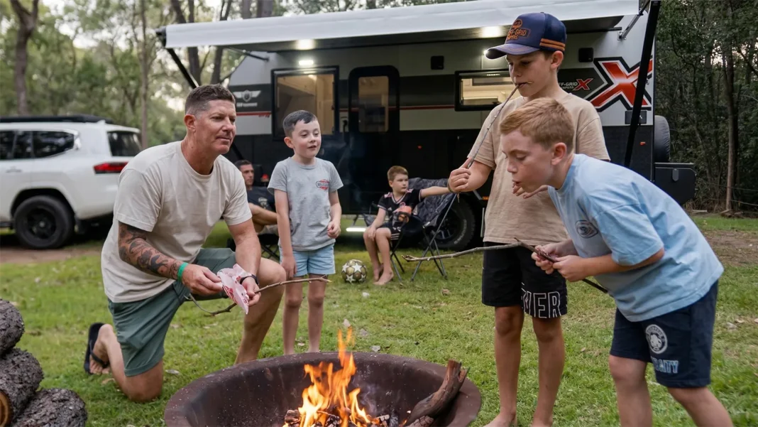 kids-toasting-marshmallows-campfire-caravan-park Children toasting marshmallows over a campfire at a caravan holiday park campsite