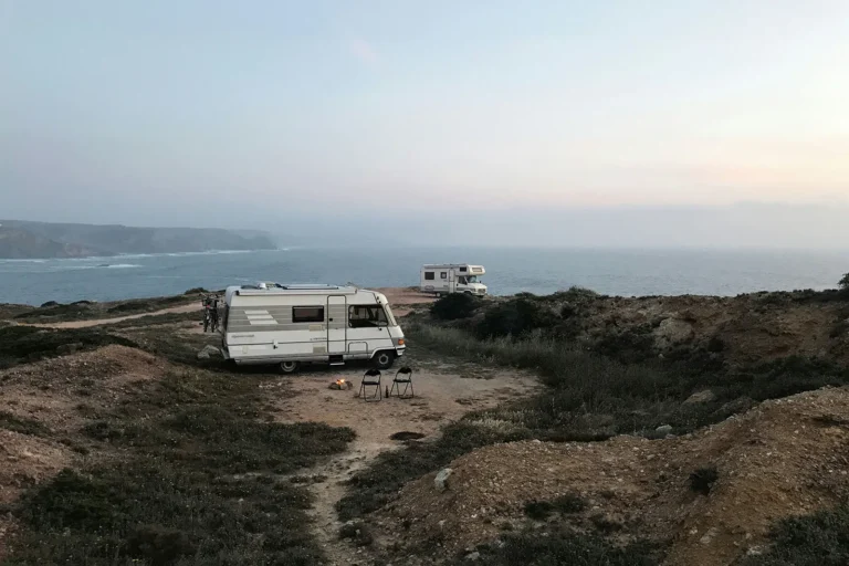 Caravans parked at remote coastal off-grid camping site overlooking the ocean