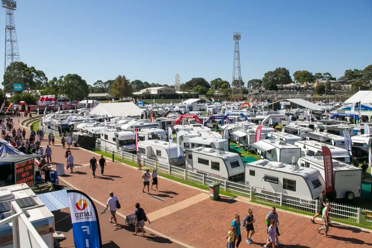 Aerial view of caravans and visitors at a caravan and camping show display.