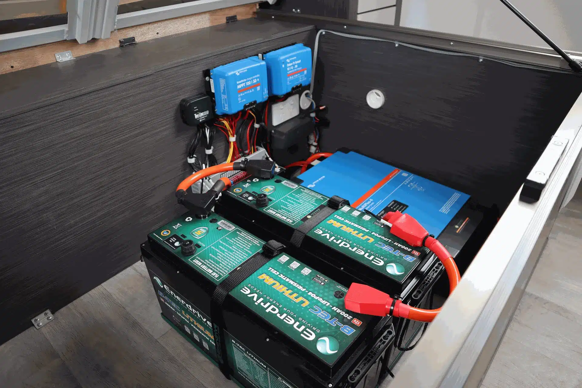 Lithium battery bank and solar charge controllers installed inside a caravan power system compartment