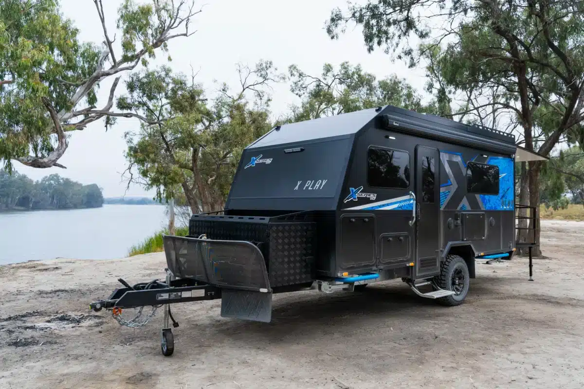 X Series X Play off-road caravan parked beside a river in the Australian bush