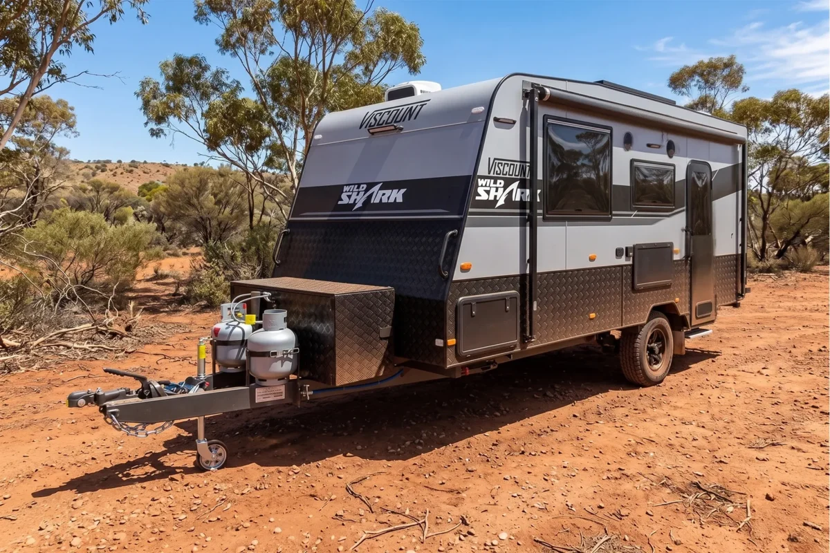 grey caravan sitting on dirt ground in aus dusty and dry climate