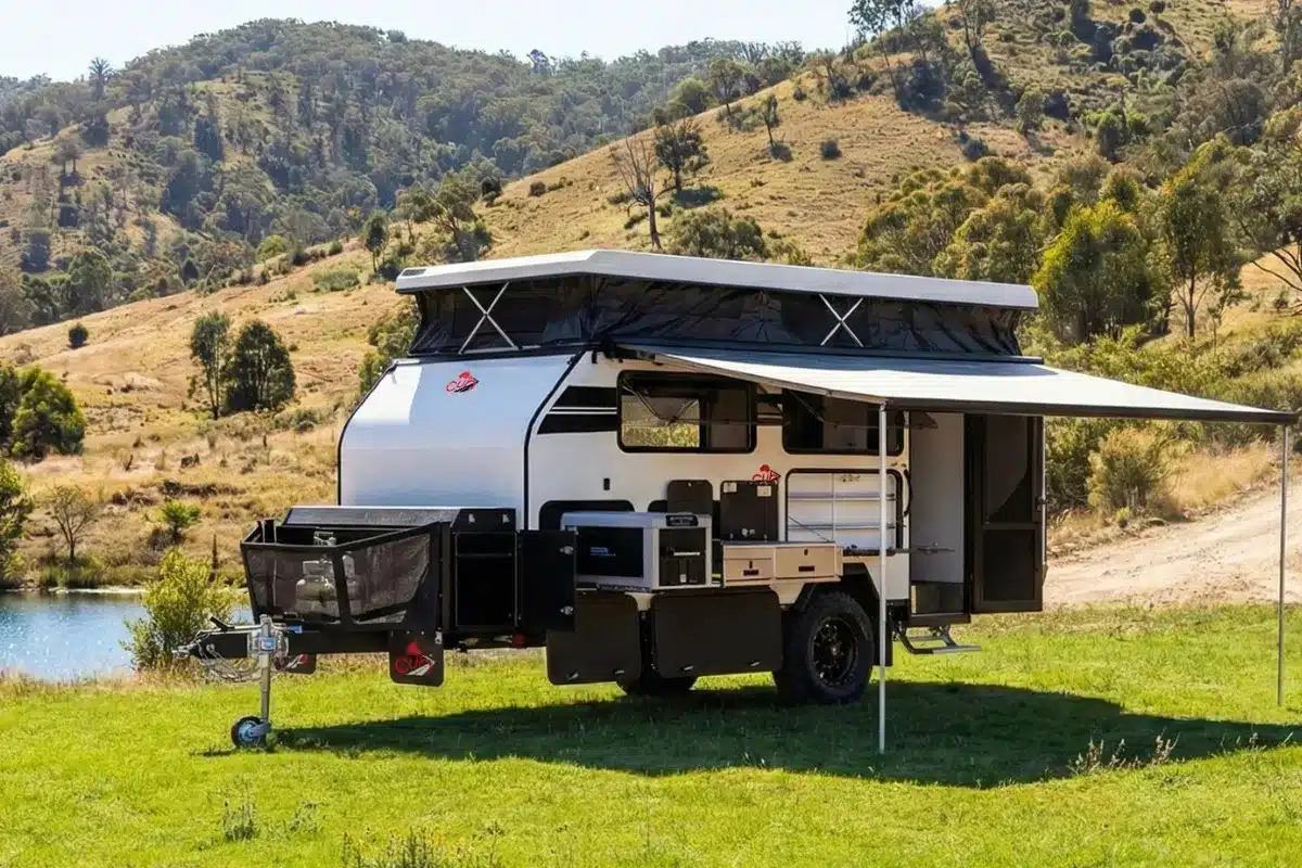 2026 CUB H16 pop-top caravan set up at a bush campsite with awning deployed