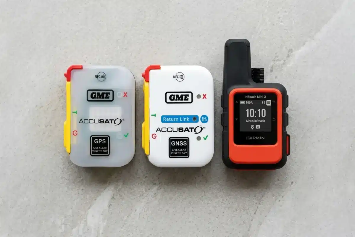 Side-by-side flat-lay comparison of GME MT610G, GME MT620GR with Return Link Service, and Garmin inReach Mini 2 on a light stone surface