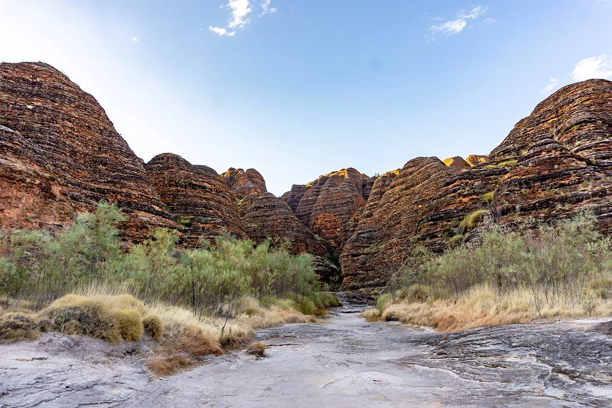 The Ord River near Kununurra in the East Kimberley region of Western Australia, with red sandstone escarpments in the background during dry season.