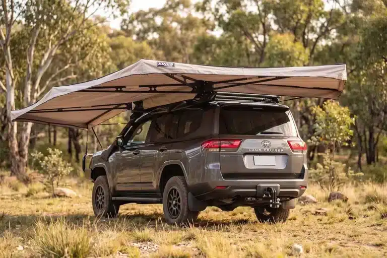 Adventure Kings 270 freestanding awning deployed over a Toyota LandCruiser at a bushland campsite