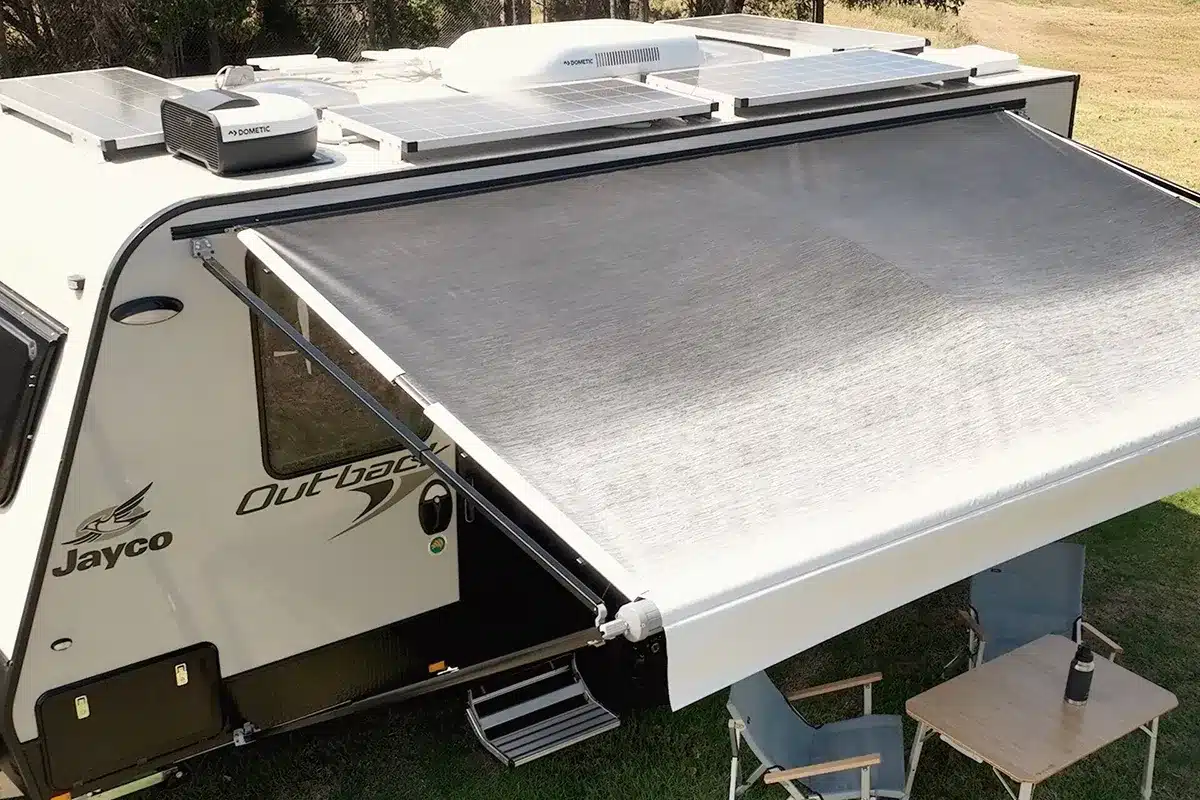 Overhead view of a Jayco Outback caravan with Dometic anti-flap kit tensioning the awning rafter arms against the roof rail