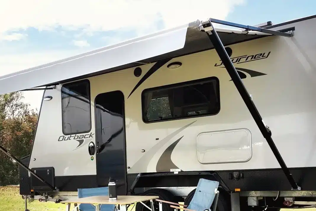 dometic-anti-flap-kit-caravan-3 Side view of a Jayco Journey Outback caravan showing the Dometic anti-flap kit installed along the full length of the awning arms